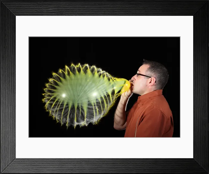 Framed Print : Man Over-Inflating Balloon Framed Print : Man Over-Inflating Balloon