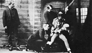 Record Prints: Criminal Being Held Down For Mug Shot, New York, 1884