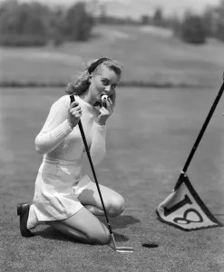 White Prints: Woman Kissing Golf Ball for Luck, Nostalgia, Vintage Sports, C.1950s